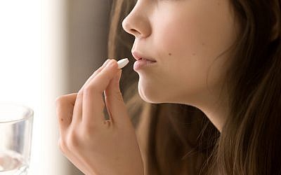 Illustrative: Close up of woman taking a pill (iStock)