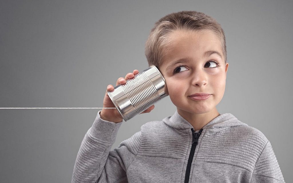 Illustrative: Boy listening via tin can phone. (iStock)