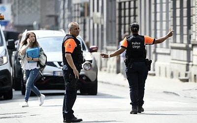 Police officers redirect traffic in the eastern Belgian city of Liege on May 29, 2018, near the site where a man shot and killed three people before being shot dead by police.  (AFP PHOTO / JOHN THYS)