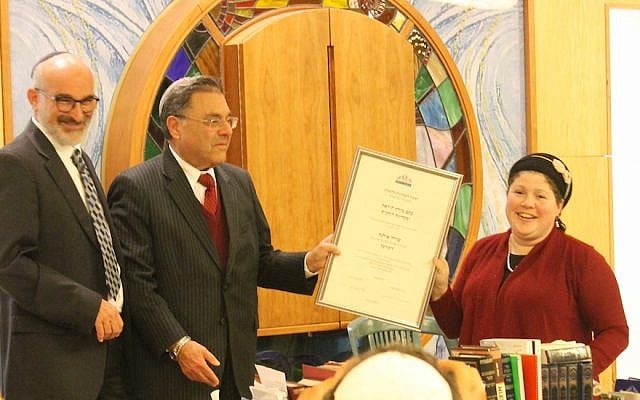 Rabbi Shlomo Riskin, chancellor of Ohr Torah Stone, presents Rabbanit Shira Zimmerman with her certification as a spiritual leader and arbiter of Jewish law at a ceremony in Jerusalem, January 3, 2017. (Ohr Torah Stone via JTA) Rabbi Shlomo Riskin, chancellor of Ohr Torah Stone, presents Rabbanit Shira Zimmerman with her certification as a spiritual leader and arbiter of Jewish law at a ceremony in Jerusalem, January 3, 2017. (Ohr Torah Stone via JTA)