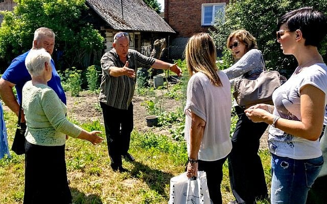 Totko Teklak, gesturing, shows a visitor from Israel where his father hid her mother during the Holocaust in eastern Poland, June 2017. (Courtesy of Lea Hirsch) Totko Teklak, gesturing, shows a visitor from Israel where his father hid her mother during the Holocaust in eastern Poland, June 2017. (Courtesy of Lea Hirsch)