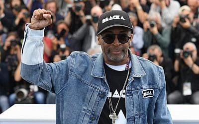 Director Spike Lee holds up a fist as he attends the photocall for 'BlacKkKlansman' during the 71st annual Cannes Film Festival at Palais des Festivals on May 15, 2018 in Cannes, France.  (Pascal Le Segretain/Getty Images via JTA)