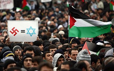 Illustrative: A Turkish demonstrator holding a banner with a Nazi swastika and Star of David in Istanbul, January 2, 2009. (Mustafa Ozer/AFP/Getty Images)