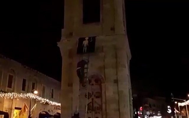 Far-right activists from the Otzma Yehudit group put up a picture of a terrorist, in the town clock in Jaffa. (Screen capture: Ynet news) Far-right activists from the Otzma Yehudit group put up a picture of a terrorist, in the town clock in Jaffa. (Screen capture: Ynet news)