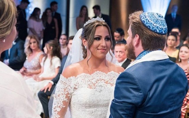 Carolinne Salvio Fróes, a contestant on the Brazilian show “Wedding Factory,” with her new husband Allan Pavlovsky de Boucherville Borges. (Victor Silva/Wedding Factory via JTA) Carolinne Salvio Fróes, a contestant on the Brazilian show “Wedding Factory,” with her new husband Allan Pavlovsky de Boucherville Borges. (Victor Silva/Wedding Factory via JTA)