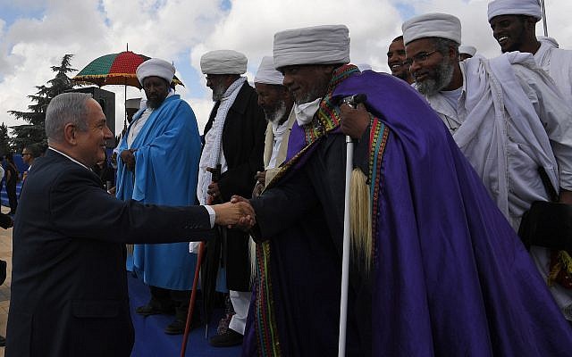 Prime Minister Benjamin Netanyahu, left, meets with member of the Ethiopian Jewish community who immigrated to Israel during an annual memorial ceremony for those who died making the journey, held at Mount Herzl in Jerusalem, May 13, 2018. (Kobi Gideon/GPO) Prime Minister Benjamin Netanyahu, left, meets with member of the Ethiopian Jewish community who immigrated to Israel during an annual memorial ceremony for those who died making the journey, held at Mount Herzl in Jerusalem, May 13, 2018. (Kobi Gideon/GPO)