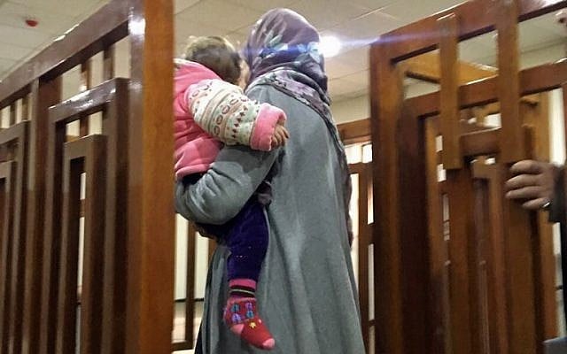 This file photo taken on February 19, 2018, shows French Jihadist Melina Boughedir carrying her son as she arrives to court in the Iraqi capital Baghdad. (AFP PHOTO / STRINGER)