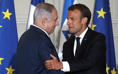 French President Emmanuel Macron, right, and Prime Minister Benjamin Netanyahu shake hands during a joint press conference at the Elysee Palace in Paris, on June 5, 2018. (Philippe Wojazer/AFP)