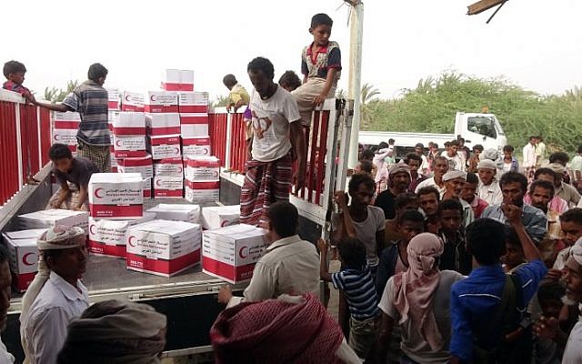 Yemenis drop off boxes of humanitarian aid provided by the Emirati Red Crescent in the coastal town of Mujailis, south of the city of Hodeida, on June 6, 2018. (AFP PHOTO / NABIL HASSAN) Yemenis drop off boxes of humanitarian aid provided by the Emirati Red Crescent in the coastal town of Mujailis, south of the city of Hodeida, on June 6, 2018. (AFP PHOTO / NABIL HASSAN)