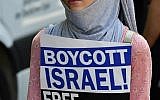 Illustrative: A protester holds a sign reading 'Boycott Israel, Free Palestine' during a Quds-day demonstration in Berlin, on June 9, 2018. (AFP PHOTO / Tobias SCHWARZ)