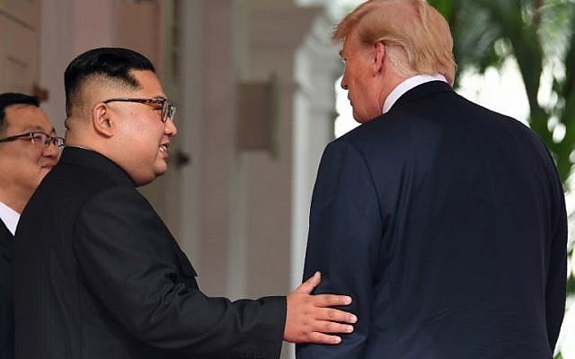 North Korea's leader Kim Jong Un (C) meets with US President Donald Trump (R) at the start of the US-North Korea summit at the Capella Hotel on Sentosa island in Singapore on June 12, 2018. (AFP Photo/Saul Loeb) North Korea's leader Kim Jong Un (C) meets with US President Donald Trump (R) at the start of the US-North Korea summit at the Capella Hotel on Sentosa island in Singapore on June 12, 2018. (AFP Photo/Saul Loeb)