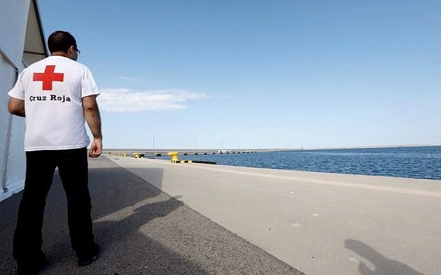 A Red Cross member stands next to tents installed at Valencia´s harbor for the reception of migrants rescued by the Aquarius rescue ship on June 16, 2018 in Valencia. (AFP/POOL/Juan Carlos Cárdenas) A Red Cross member stands next to tents installed at Valencia´s harbor for the reception of migrants rescued by the Aquarius rescue ship on June 16, 2018 in Valencia. (AFP/POOL/Juan Carlos Cárdenas)