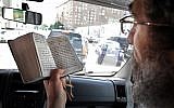 In this file photo taken on June 16, 2009 Russian Rabbi Boroukh Kleinberg reads from the Torah inside his Mitzvah Bus in Moscow. (AFP Photo/Alexander Nemenov)
