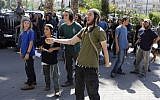 Illustrative: Israeli supporters of the two Jewish suspected in the arson attack that killed a Palestinian toddler and his parents, demonstrate outside of a Lod court, on June 19, 2018. (AFP/AHMAD GHARABLI)