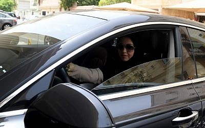 Daniah al-Ghalbi, a newly-licensed Saudi woman driver, sits in her car during a test-drive in the Red Sea resort of Jeddah on June 23, 2018, a day before the lifting of a ban on women driving in the conservative Arab kingdom. (AFP / Amer HILABI)