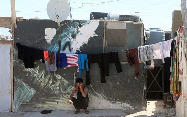 A young Syrian man sits outside a tent in a refugee camp on the outskirts of the town of Zahle in Lebanon's Bekaa Valley on June 23, 2018. (AFP PHOTO / HAITHAM MOUSSAWI) A young Syrian man sits outside a tent in a refugee camp on the outskirts of the town of Zahle in Lebanon's Bekaa Valley on June 23, 2018. (AFP PHOTO / HAITHAM MOUSSAWI)
