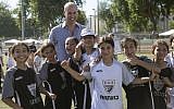 Britain's Prince William poses for a group photo with Jewish and Arab children at the Neve Golan Stadium in the Israeli Mediterranean coastal city of Jaffa on June 26, 2018. (AFP PHOTO / POOL / Heidi Levine)