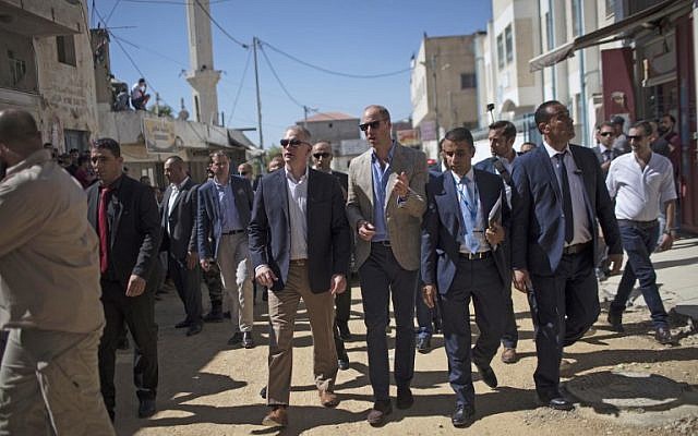 Britain's Prince William, center, walks through Jalazoun refugee camp near the West Bank city of Ramallah on June 27, 2018. (AFP / POOL / Fadi AROURI)