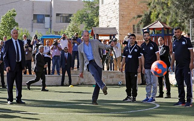 Britain's Prince William kicks a ball next to the head of the Palestinian Football Federation, Jibril Rajoub, left, in the West Bank city of Ramallah on June 27, 2018. (AFP / Ahmad GHARABLI)