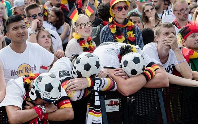 Supporters of the German national football team react as they attend a public viewing event at the Fanmeile in Berlin to watch the Russia 2018 World Cup Group F football match between South Korea and Germany on June 27, 2018. (AFP PHOTO / dpa / Bernd von Jutrczenka) Supporters of the German national football team react as they attend a public viewing event at the Fanmeile in Berlin to watch the Russia 2018 World Cup Group F football match between South Korea and Germany on June 27, 2018. (AFP PHOTO / dpa / Bernd von Jutrczenka)