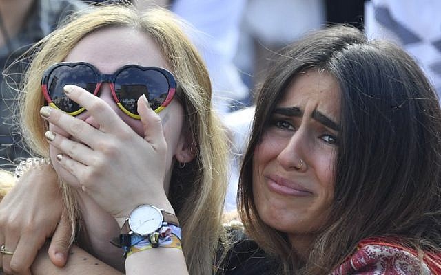 Supporters of the German national football team react as they attend a public viewing event at the Fanmeile in Berlin to watch the Russia 2018 World Cup Group F football match between South Korea and Germany on June 27, 2018. (AFP PHOTO / John MACDOUGALL)