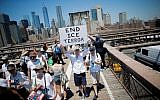 Demonstrators cross the Brooklyn Bridge during a march against the separation of families caught illegally crossing the US-Mexico border, on June 30, 2018 in New York. (AFP Photo/Eduardo Munoz Alvarez)