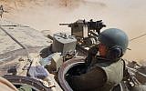 A female soldier operates a tank in the Negev desert, in an undated photograph. (Israel Defense Forces)