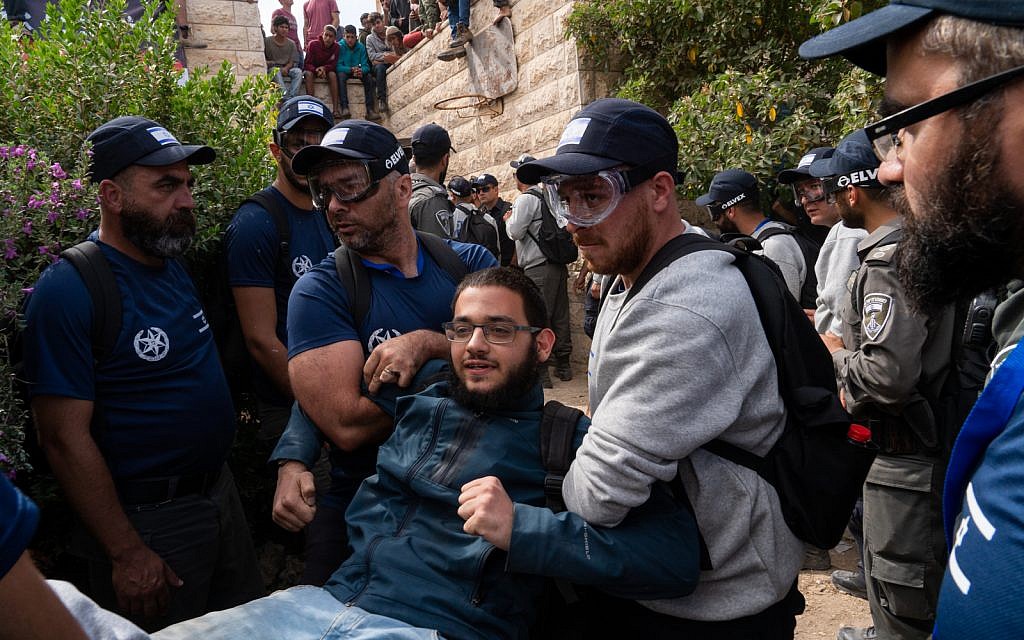 Police remove a demonstrator from a home in Netiv Ha'avot, June 12, 2018. (Luke Tress/Times of Israel) Police remove a demonstrator from a home in Netiv Ha'avot, June 12, 2018. (Luke Tress/Times of Israel)