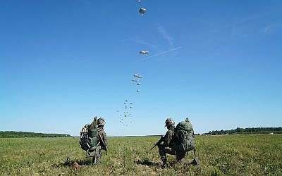Israeli soldiers take position as other paratroopers land behind them during the US-led Swift Response exercise in Europe in June 2018. (Israel Defense Forces)