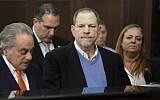 In this May 25, 2018 file photo, Harvey Weinstein, center, listens during a court proceeding in New York during his arraignment on rape and other charges. (Steven Hirsch/New York Post via AP, Pool)