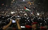 Jordanian protesters shout slogans and raise a national flag during a demonstration outside the Prime Minister's office in the capital Amman early June 4, 2018. (AP Photo/Raad Adayleh)