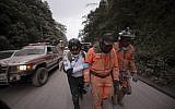 Firefighters leave the evacuation area near Volcan de Fuego, or Volcano of Fire, in El Rodeo, Guatemala, June 3, 2018. (AP/Santiago Billy)