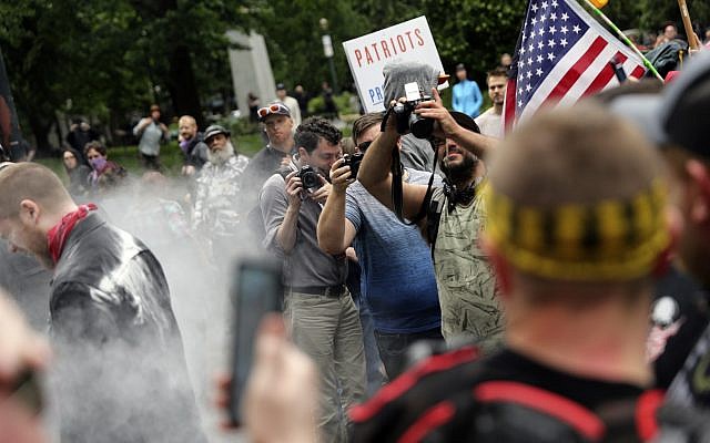 In this June 3, 2018, file photo, photographers capture dueling US demonstrations between antifascists known as antifa and a right wing group called Patriot Prayer in downtown Portland, Oregon. (Mark Graves/The Oregonian via AP, file) In this June 3, 2018, file photo, photographers capture dueling US demonstrations between antifascists known as antifa and a right wing group called Patriot Prayer in downtown Portland, Oregon. (Mark Graves/The Oregonian via AP, file)