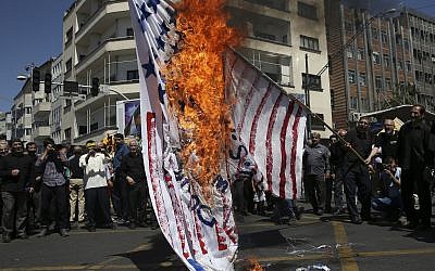 Iranian protesters burn a representation of the US flag in their annual anti-Israeli Al-Quds, Jerusalem, Day rally in Tehran, Iran, June 8, 2018. (Vahid Salemi/AP)