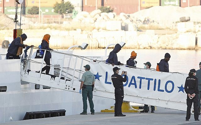 Migrants descend the Italian coast guard vessel Dattilo upon arrival at the eastern port of Valencia, Spain, Sunday, June 17, 2018. (AP/Alberto Saiz) Migrants descend the Italian coast guard vessel Dattilo upon arrival at the eastern port of Valencia, Spain, Sunday, June 17, 2018. (AP/Alberto Saiz)
