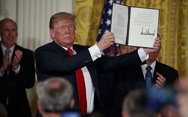 US President Donald Trump shows off a 'Space Policy Directive' after signing it during a meeting of the National Space Council at the White House on June 18, 2018. (AP Photo/Evan Vucci) US President Donald Trump shows off a 'Space Policy Directive' after signing it during a meeting of the National Space Council at the White House on June 18, 2018. (AP Photo/Evan Vucci)