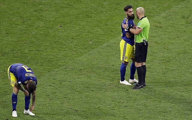 Referee Szymon Marcniak of Poland, right, talks with Sweden's Jimmy Durmaz, middle, at the end the group F match between Germany and Sweden at the 2018 soccer World Cup in the Fisht Stadium in Sochi, Russia, Saturday, June 23, 2018. (AP/Sergei Grits) Referee Szymon Marcniak of Poland, right, talks with Sweden's Jimmy Durmaz, middle, at the end the group F match between Germany and Sweden at the 2018 soccer World Cup in the Fisht Stadium in Sochi, Russia, Saturday, June 23, 2018. (AP/Sergei Grits)