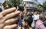 A group of protesters chant slogans at the main gate of old grand bazaar in Tehran, Iran, on June 25, 2018. (Iranian Labor News Agency via AP)