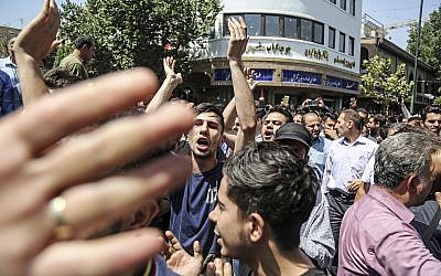 A group of protesters chant slogans at the main gate of old grand bazaar in Tehran, Iran, on June 25, 2018. (Iranian Labor News Agency via AP)