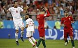 Portugal's Cristiano Ronaldo, center, reacts after failing to score a penalty as Iran's Morteza Pouraliganji reacts, left, during the group B match between Iran and Portugal at the 2018 soccer World Cup at the Mordovia Arena in Saransk, Russia, June 25, 2018. (Francisco Seco/AP)