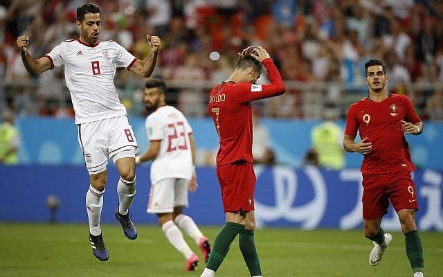 Portugal's Cristiano Ronaldo, center, reacts after failing to score a penalty as Iran's Morteza Pouraliganji reacts, left, during the group B match between Iran and Portugal at the 2018 soccer World Cup at the Mordovia Arena in Saransk, Russia, June 25, 2018. (Francisco Seco/AP) Portugal's Cristiano Ronaldo, center, reacts after failing to score a penalty as Iran's Morteza Pouraliganji reacts, left, during the group B match between Iran and Portugal at the 2018 soccer World Cup at the Mordovia Arena in Saransk, Russia, June 25, 2018. (Francisco Seco/AP)