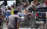 In this August 12, 2017, file photo, people fly into the air as a vehicle is driven into a group of protesters demonstrating against a white nationalist rally in Charlottesville, Virginia. (Ryan M. Kelly/The Daily Progress via AP, File)