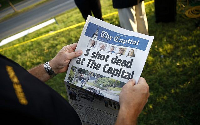 Steve Schuh, county executive of Anne Arundel County, holds a copy of The Capital Gazette near the scene of a shooting at the newspaper's office, Friday, June 29, 2018, in Annapolis, Md. A man armed with smoke grenades and a shotgun attacked journalists in the building Thursday, killing several people before police quickly stormed the building and arrested him, police and witnesses said. (AP Photo/Patrick Semansky) Steve Schuh, county executive of Anne Arundel County, holds a copy of The Capital Gazette near the scene of a shooting at the newspaper's office, Friday, June 29, 2018, in Annapolis, Md. A man armed with smoke grenades and a shotgun attacked journalists in the building Thursday, killing several people before police quickly stormed the building and arrested him, police and witnesses said. (AP Photo/Patrick Semansky)