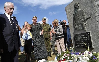 Illustrative: People stand during an unveiling ceremony of the monument to Estonian soldiers fighting alongside the Nazis against the Soviet army, in Lihula, Estonia, Friday, Aug. 20, 2004.  (AP Photo/NIPA)