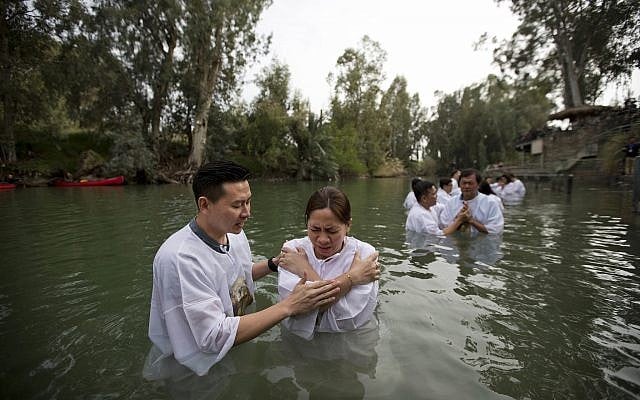 Indonesian priests baptize Christian pilgrims in the Jordan river at Yardenit baptismal site in Israel, March 17, 2017. (AP Photo/Dusan Vranic) Indonesian priests baptize Christian pilgrims in the Jordan river at Yardenit baptismal site in Israel, March 17, 2017. (AP Photo/Dusan Vranic)