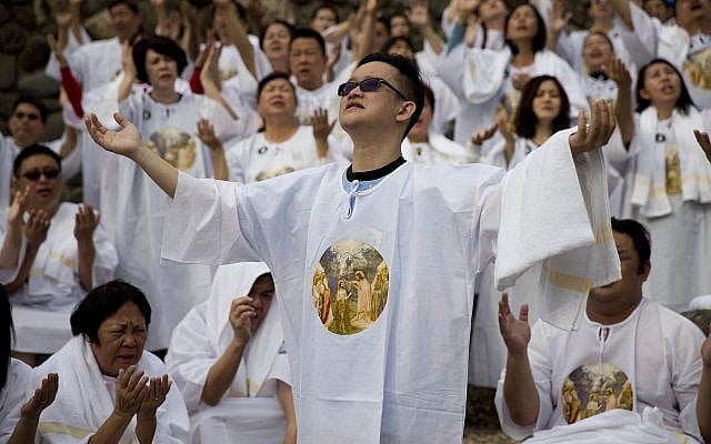 Indonesian Christian pilgrims sing before a baptismal ceremony in Jordan river at the Yardenit baptismal site in Israel, March 17, 2017. (AP Photo/Dusan Vranic)