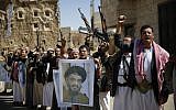 FILE - In this March 3, 2016 photo, Shiite rebels, known as Houthis, hold a poster of Hezbollah leader Hassan Nasrallah during a rally in support of Hezbollah, in Sanaa, Yemen. (AP Photo/Hani Mohammed, File)