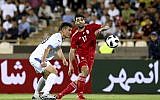 Iran's Mehdi Taremi (R) plays the ball during the international friendly soccer match between Iran and Uzbekistan at the Azadi Stadium in Tehran, Iran on May 19, 2018. (AP Photo/Ebrahim Noroozi)