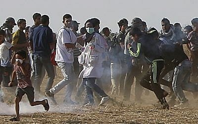 Volunteer paramedic Razan al-Najjar, 21, center, is seen before reportedly being shot in her chest by Israeli troops during a protest east of Khan Younis, Gaza Strip, Friday, June 1, 2018 (AP Photo/Adel Hana)