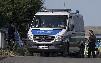 Police officers block a road near Wiesbaden, Germany, June 7, 2018. (Boris Roessler/dpa via AP)